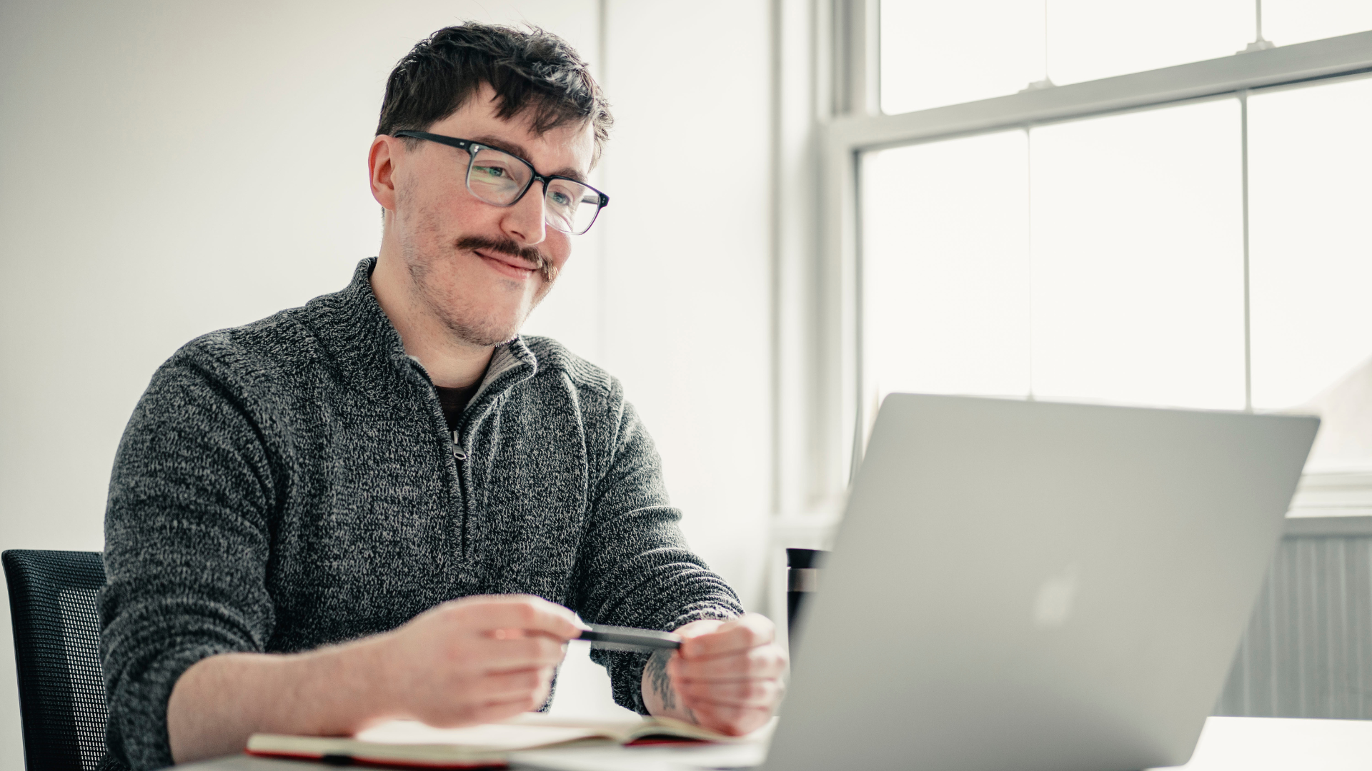 Person looking at laptop and studying